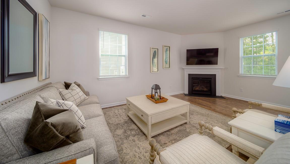 1208 Secrest Cmns Drive Monroe, NC 28112 - Photo 11 of 40 a living room with furniture a flat screen tv and a fireplace