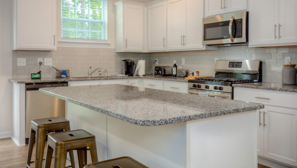 1208 Secrest Cmns Drive Monroe, NC 28112 - Photo 14 of 40 a kitchen with stainless steel appliances granite countertop a sink stove and microwave
