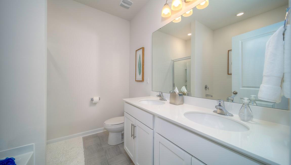 1208 Secrest Cmns Drive Monroe, NC 28112 - Photo 23 of 40 a bathroom with a sink a toilet and a mirror