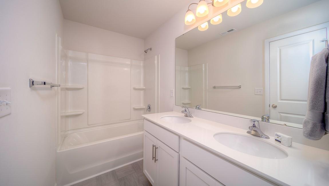 1208 Secrest Cmns Drive Monroe, NC 28112 - Photo 29 of 40 a bathroom with a tub a sink and mirror