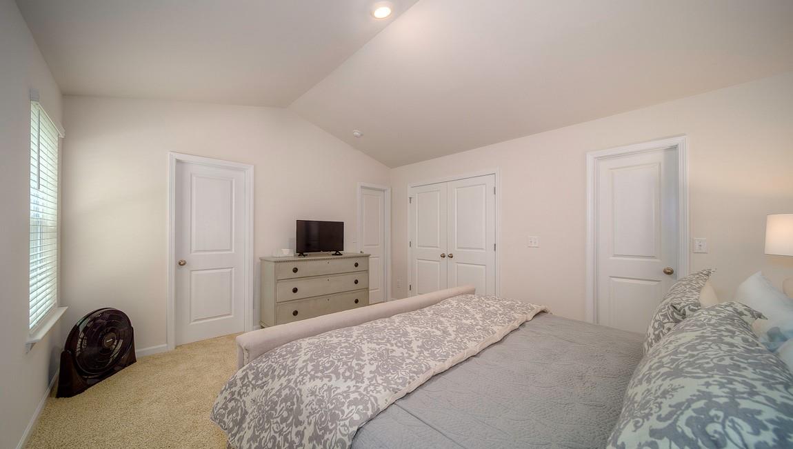 1208 Secrest Cmns Drive Monroe, NC 28112 - Photo 37 of 40 a bedroom with a bed and a flat tv screen on dresser