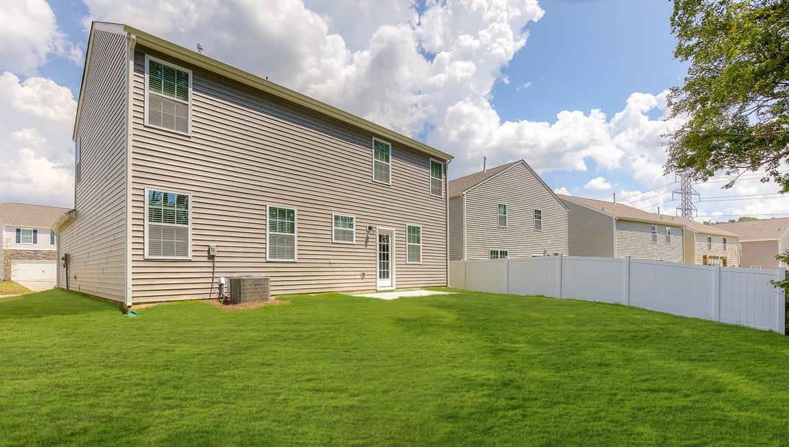 1208 Secrest Cmns Drive Monroe, NC 28112 - Photo 38 of 40 a front view of a house with a yard and garage