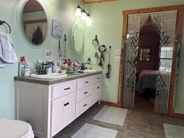 a bedroom with a bed and a mirror