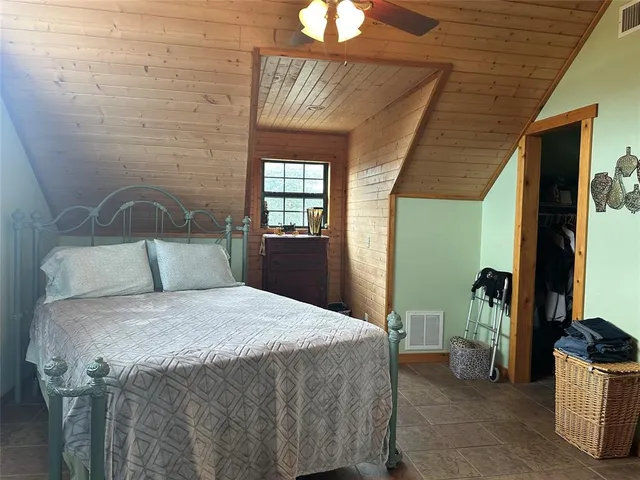 a view of a patio with dining table and chairs under an umbrella with a fire pit