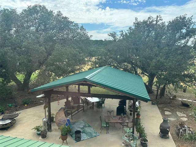 a view of a house with backyard and sitting area