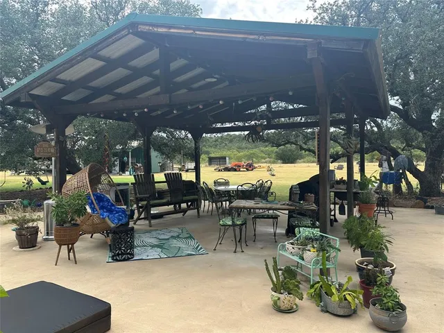 a view of a yard with furniture and a lake view