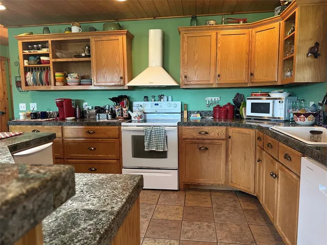 a kitchen with a sink a stove and cabinets
