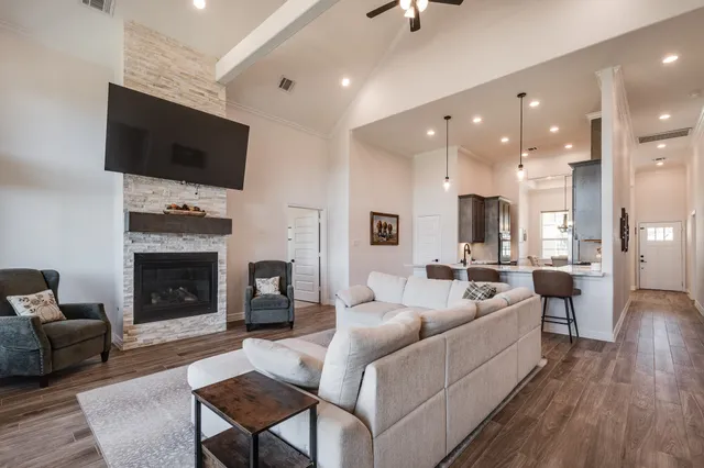 a living room with furniture a fireplace and a flat screen tv