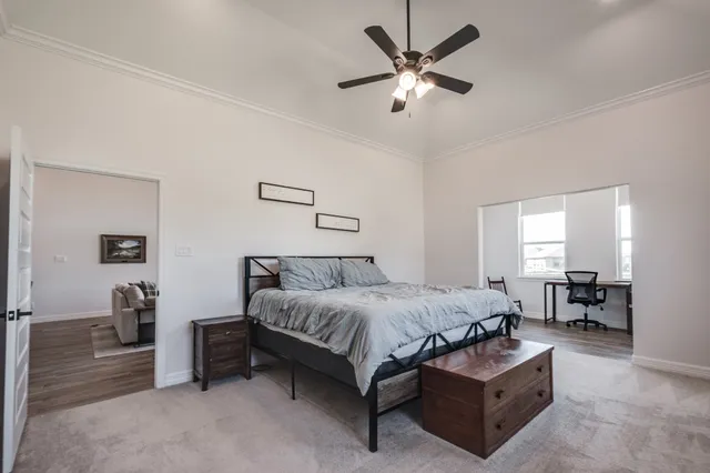 a bedroom with a bed chairs and a chandelier