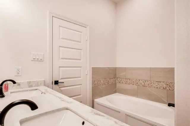 a bathroom with a bathtub and sink