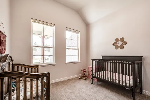a view of a bedroom with wooden floor and a window