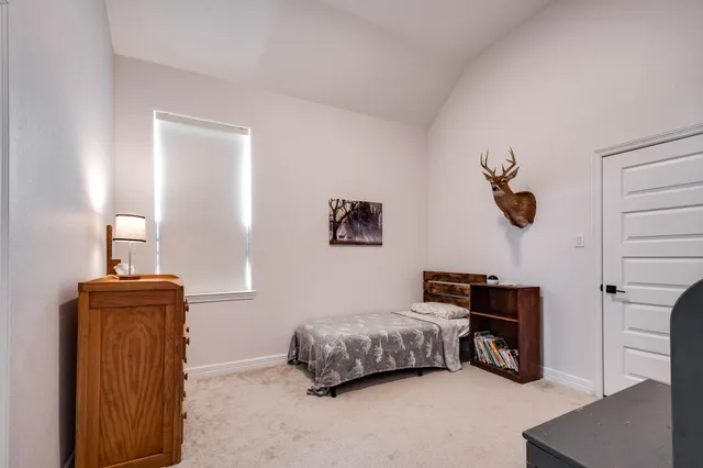 a bedroom with furniture and a window