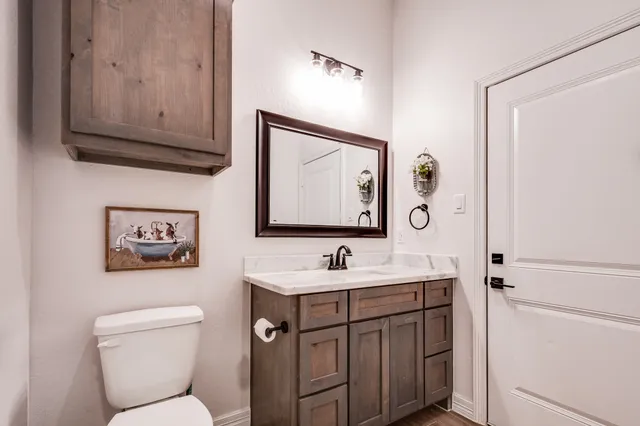 a bathroom with a toilet sink and mirror