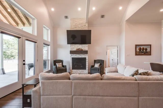 a living room with furniture a flat screen tv and a fireplace