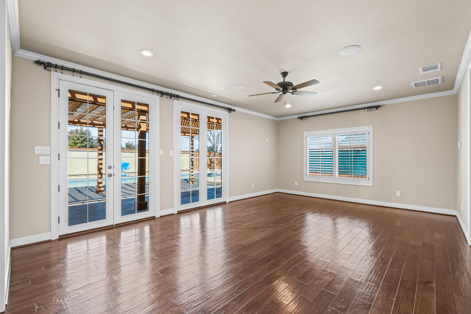 1405 11th Place Shallowater, TX 79363 - Photo 13 of 81 wooden floor in an empty room with a window