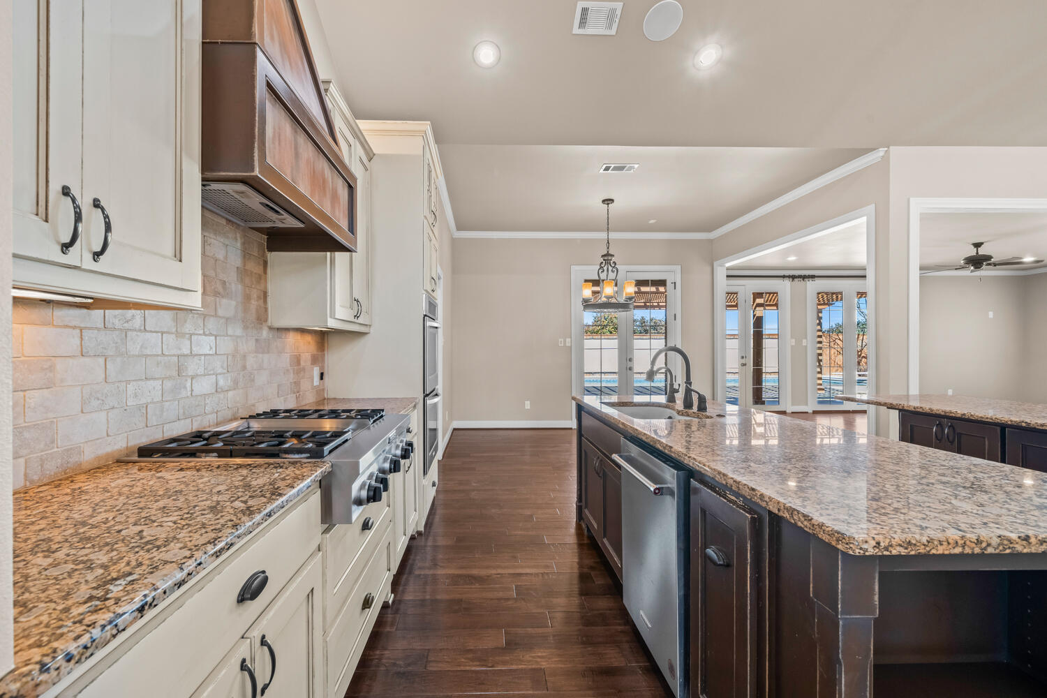 1405 11th Place Shallowater, TX 79363 - Photo 17 of 81 a kitchen with granite countertop stove a sink and dishwasher