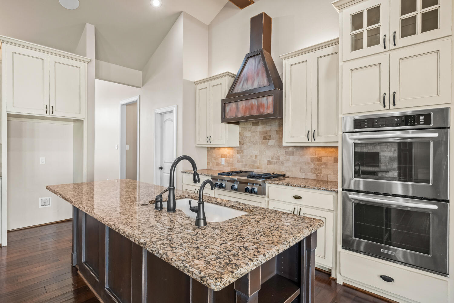 1405 11th Place Shallowater, TX 79363 - Photo 20 of 81 a kitchen with stainless steel appliances granite countertop a kitchen island a stove a sink dishwasher and cabinets with wooden floor