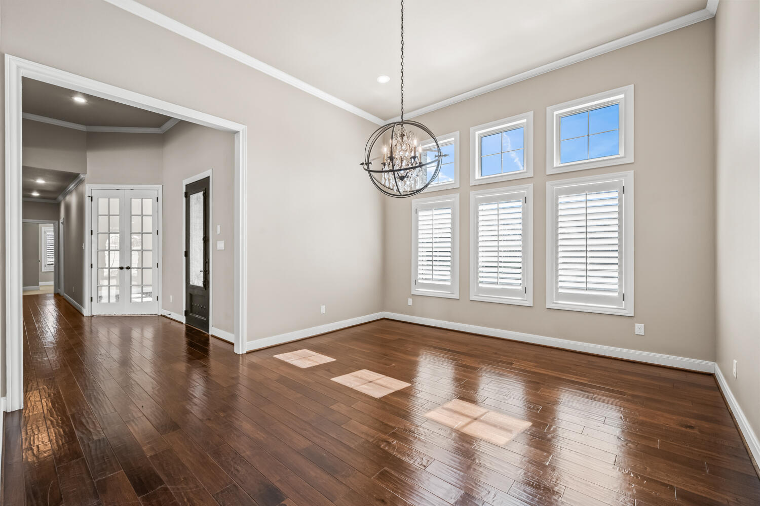 1405 11th Place Shallowater, TX 79363 - Photo 23 of 81 a view of an empty room with wooden floor and a window