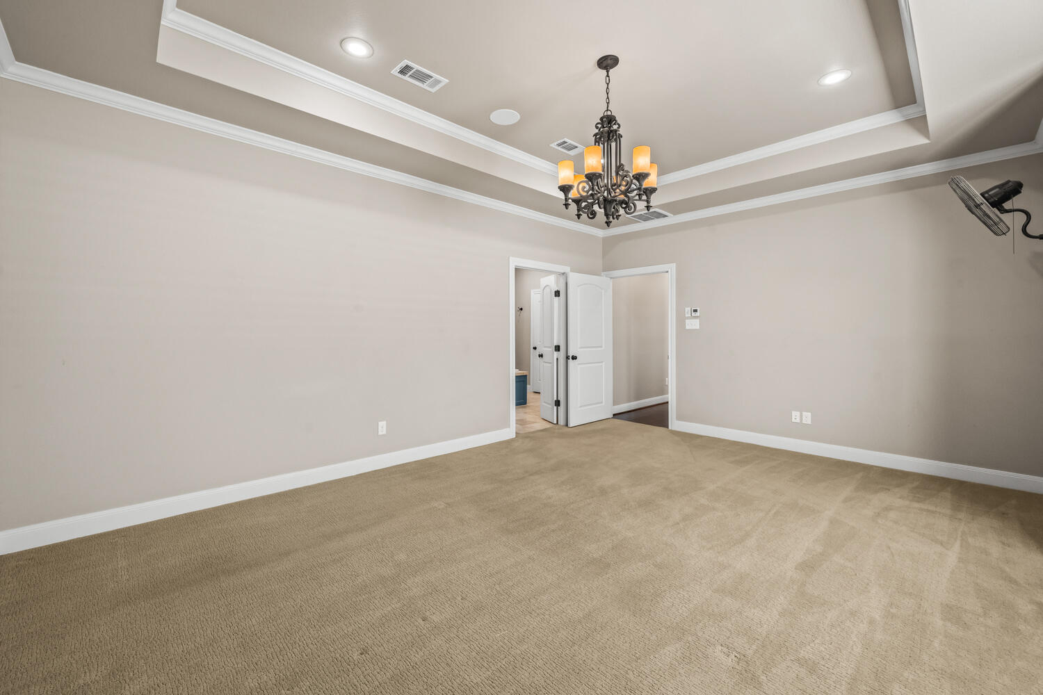 1405 11th Place Shallowater, TX 79363 - Photo 27 of 81 an empty room with a chandelier fan and wooden floor