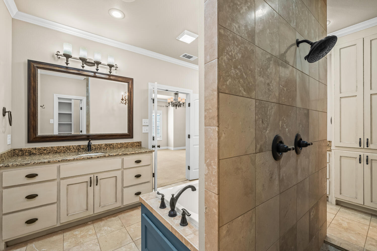 1405 11th Place Shallowater, TX 79363 - Photo 33 of 81 a bathroom with a granite countertop sink a mirror a bathtub and shower