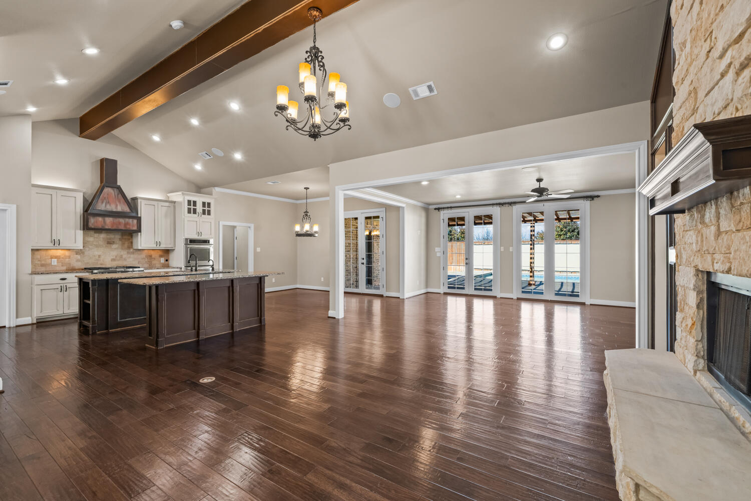 1405 11th Place Shallowater, TX 79363 - Photo 7 of 81 a view of a living room and kitchen with furniture wooden floor and a large window