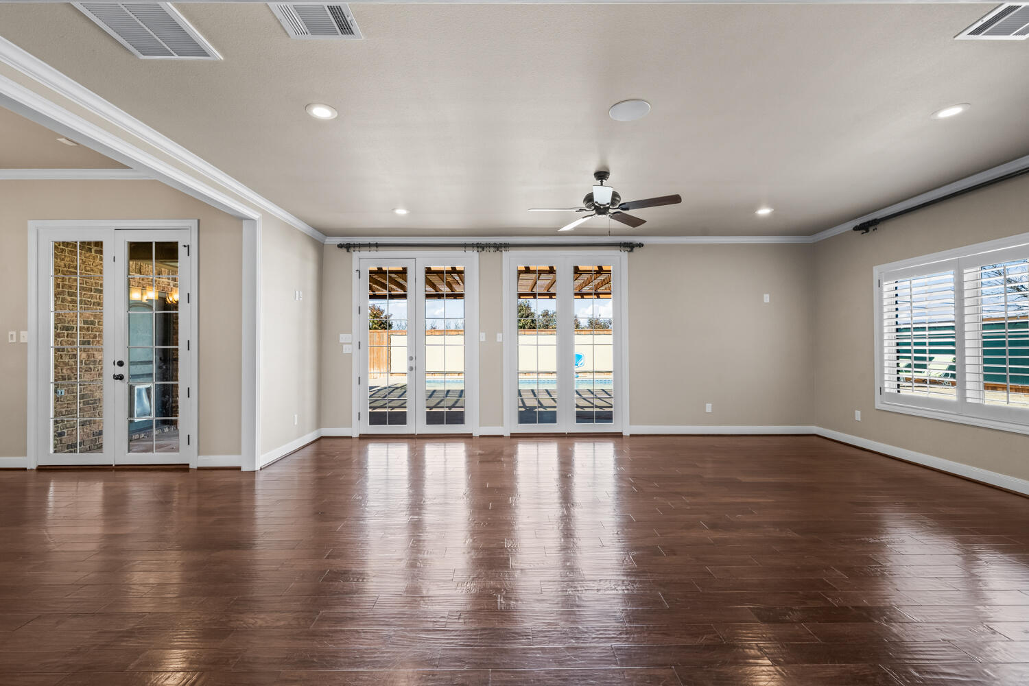 1405 11th Place Shallowater, TX 79363 - Photo 9 of 81 an empty room with wooden floor and windows