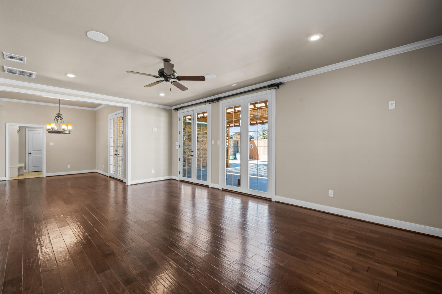 1405 11th Place Shallowater, TX 79363 - Photo 10 of 81 a view of an empty room with wooden floor and a window