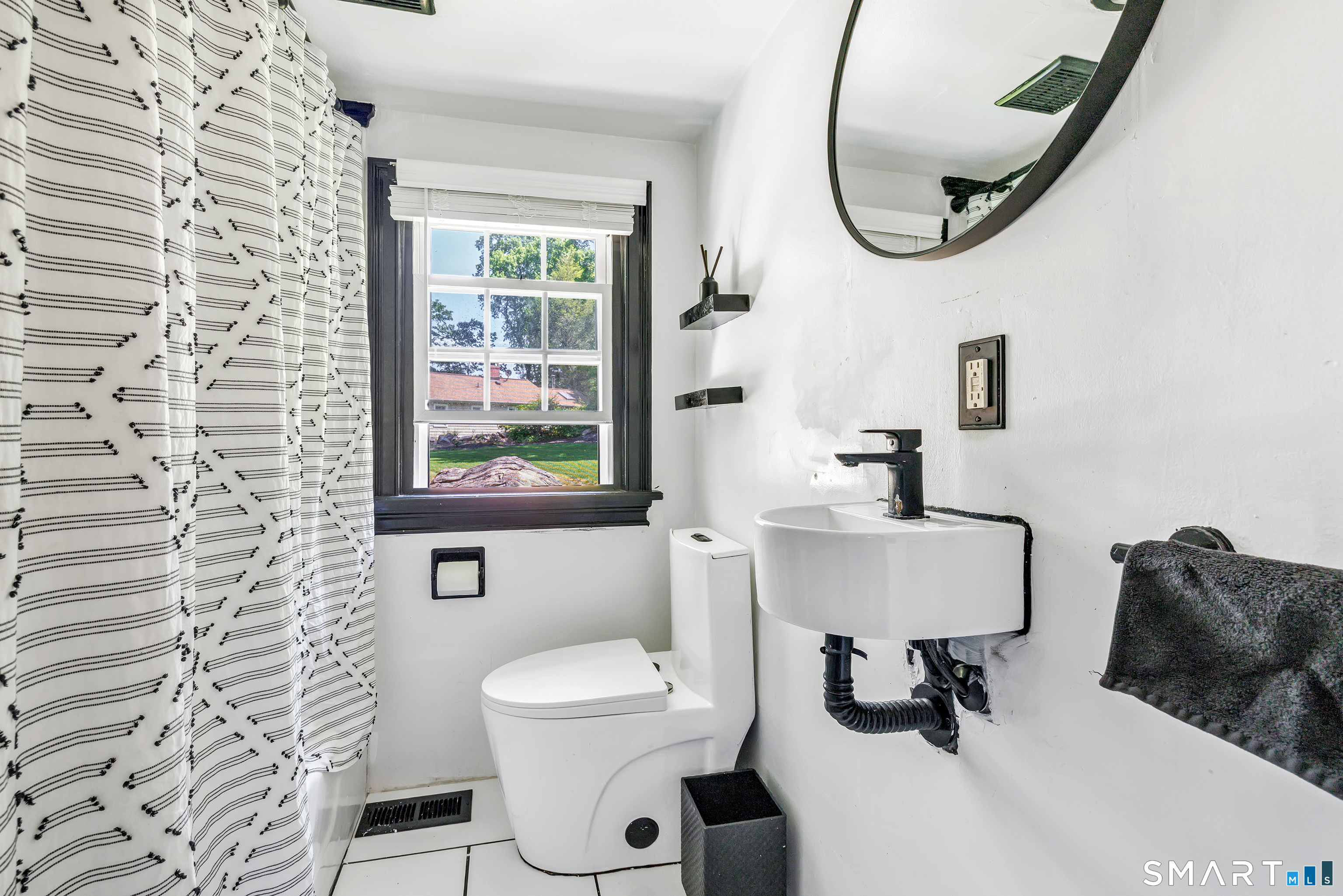 57 Olmstead Road Redding, CT 06896 - Photo 14 of 22 a bathroom with a toilet a sink and a mirror