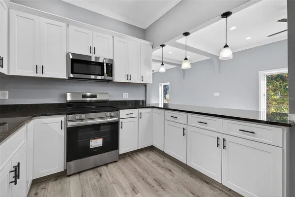 a kitchen with white cabinets stainless steel appliances and white cabinets