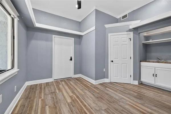 a view of a room with wooden floor and cabinet