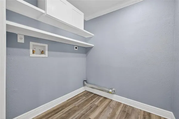 a view of a small space with wooden floor and a window