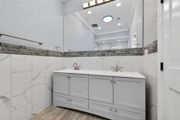 a bathroom with a sink and mirror
