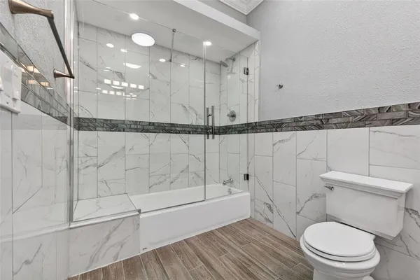 a bathroom with a toilet a sink and shower