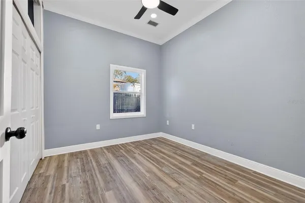 wooden floor in an empty room with a window