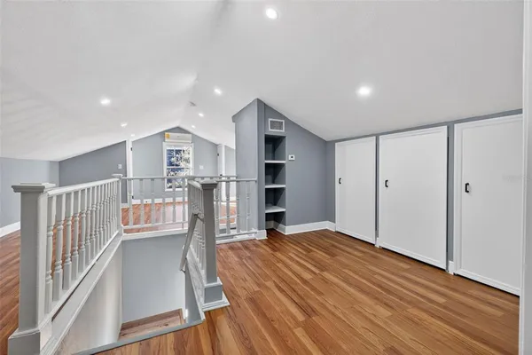 a view of empty room with wooden floor