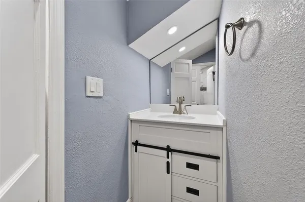 a bathroom with a sink a vanity and a mirror