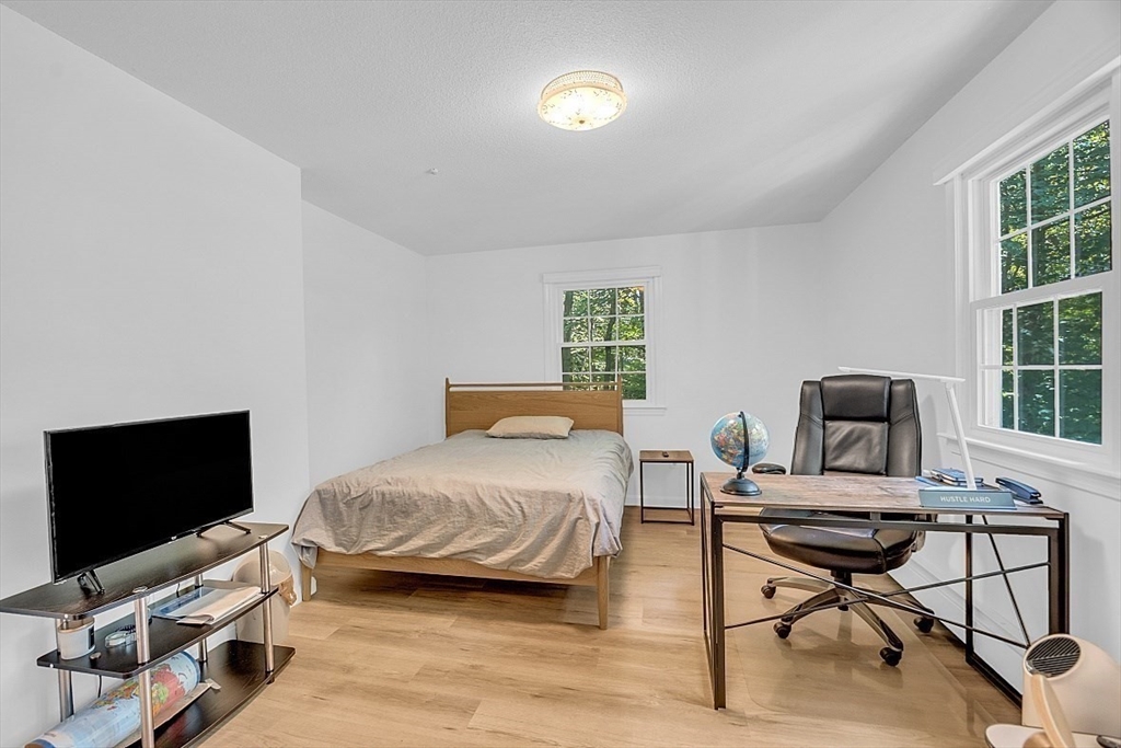 113 Townsend Road Shirley, MA 01464 - Photo 21 of 30 a bedroom with a bed and a flat screen tv