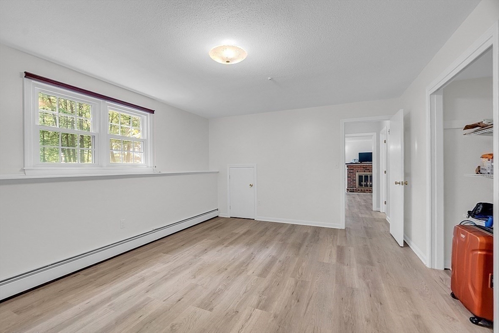 113 Townsend Road Shirley, MA 01464 - Photo 26 of 30 an empty room with wooden floor and windows