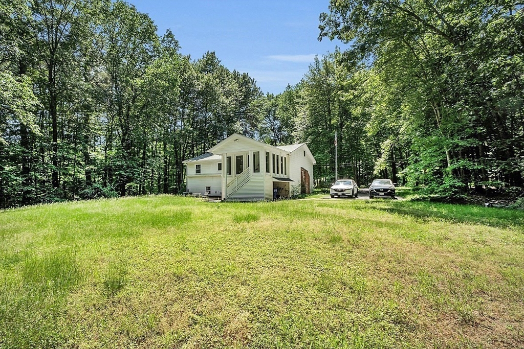 113 Townsend Road Shirley, MA 01464 - Photo 5 of 30 a house view with swimming pool in front of it