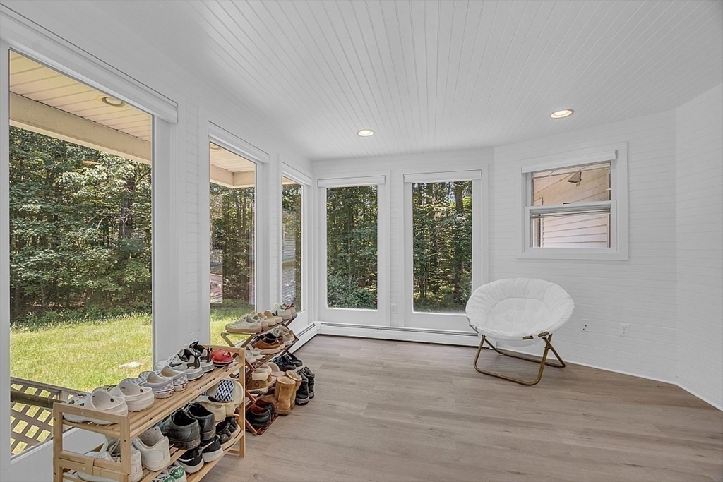 113 Townsend Road Shirley, MA 01464 - Photo 9 of 30 a living room with furniture and floor to ceiling windows