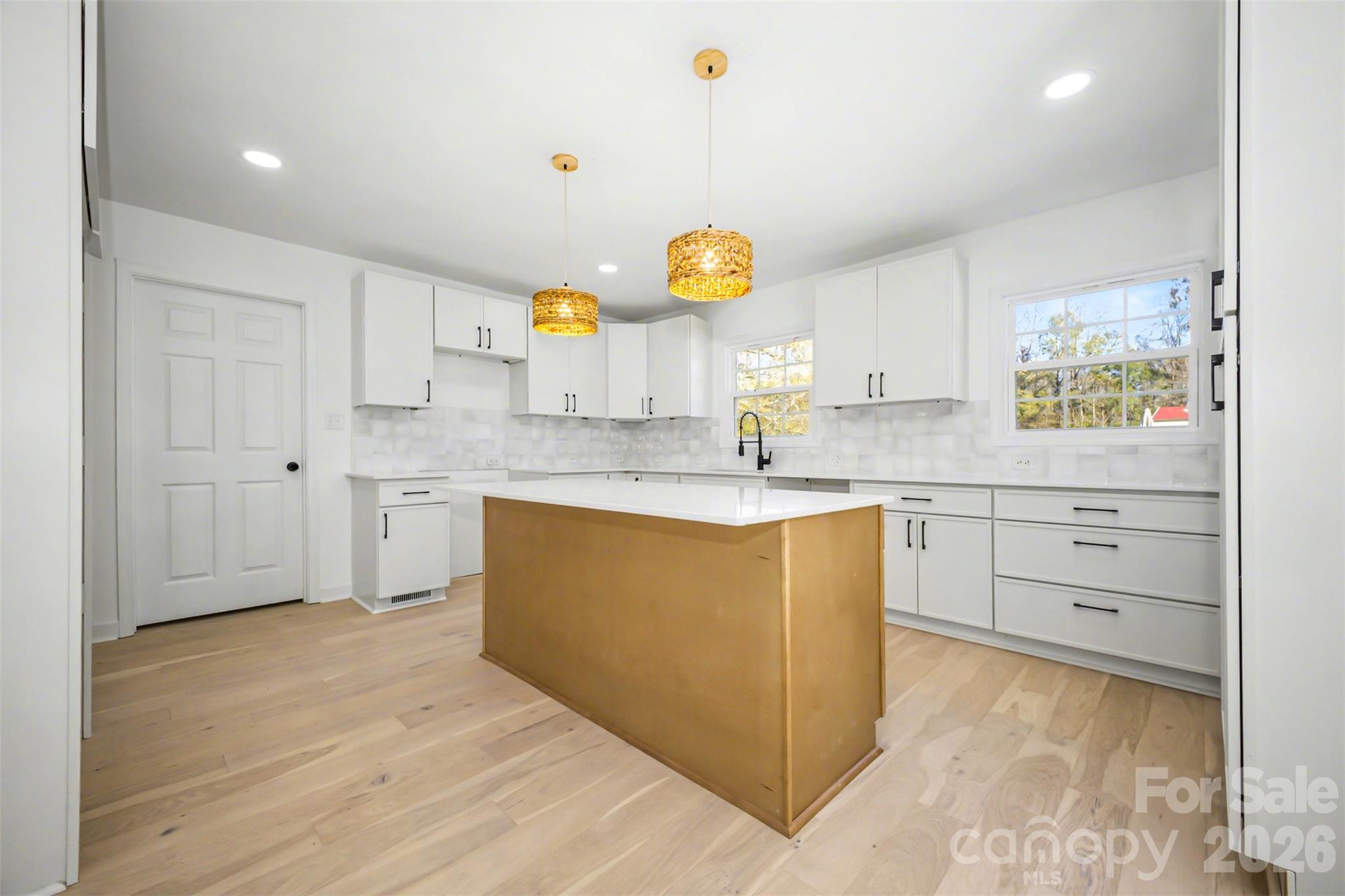 211 Ole Simpson Place Catawba, SC 29704 - Photo 13 of 38 a kitchen with granite countertop a sink cabinets stainless steel appliances and a window