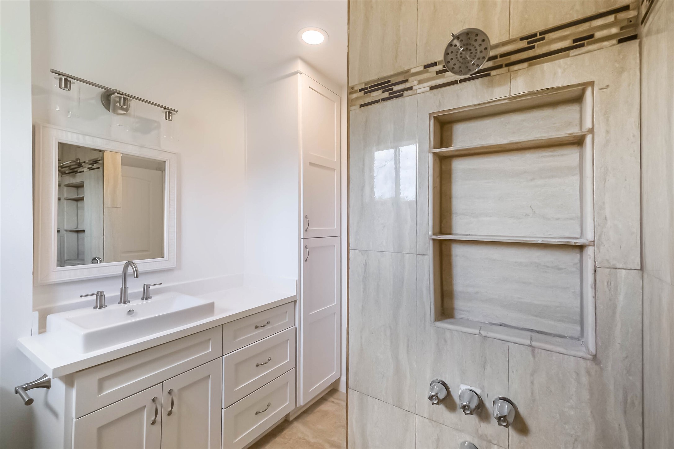 7543 Greenstone Street Houston, TX 77087 - Photo 13 of 24 a bathroom with a shower sink and mirror