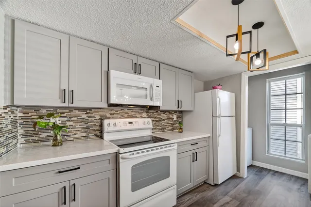 a kitchen with appliances a sink and cabinets