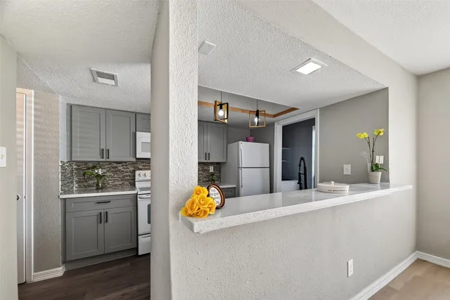 a kitchen with a sink and a refrigerator