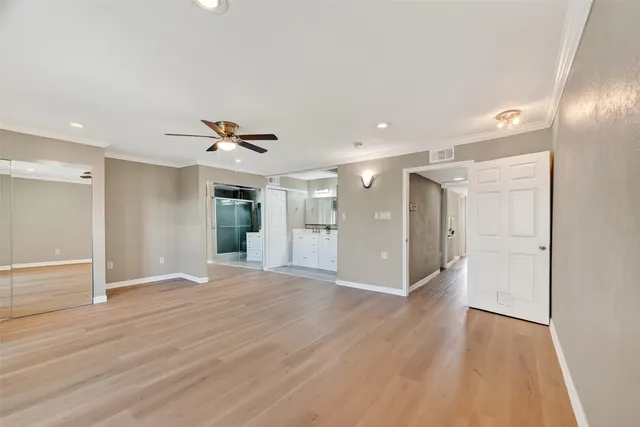 a view of empty room with wooden floor