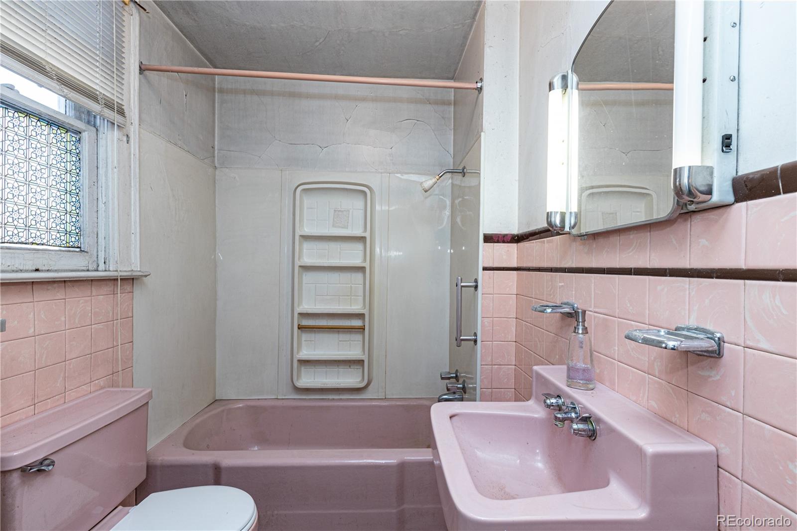 4494 Meade Street Denver, CO 80211 - Photo 13 of 24 a bathroom with a sink toilet and shower