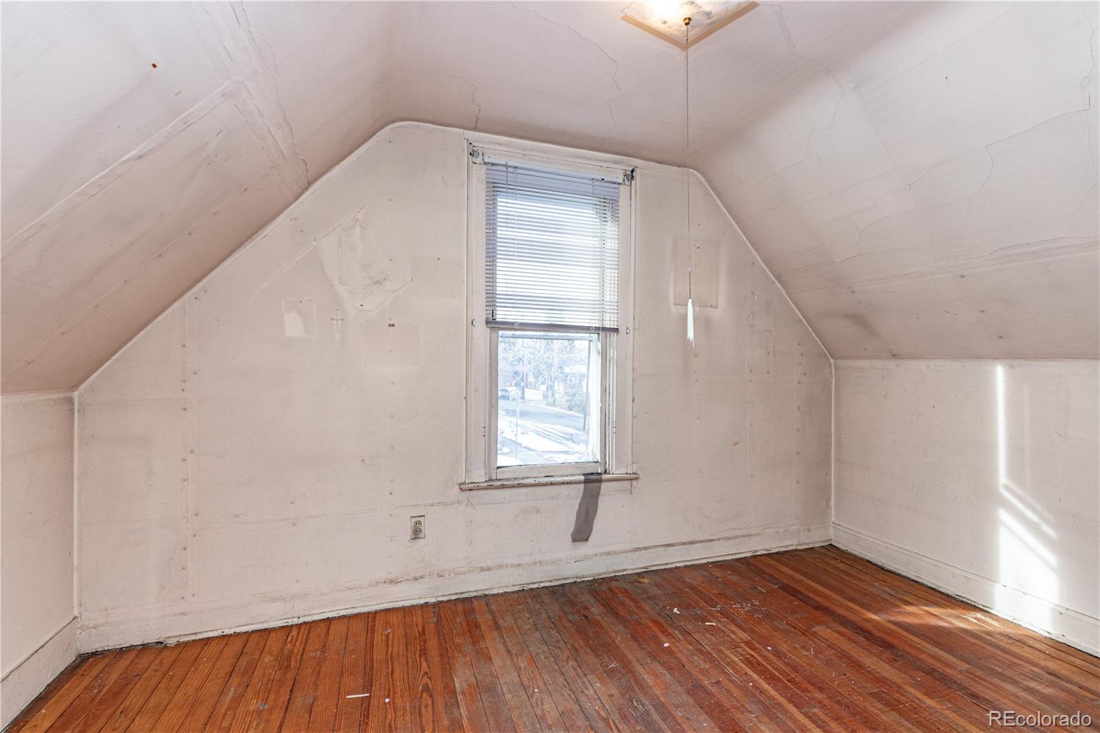 4494 Meade Street Denver, CO 80211 - Photo 15 of 24 an empty room with wooden floor and windows