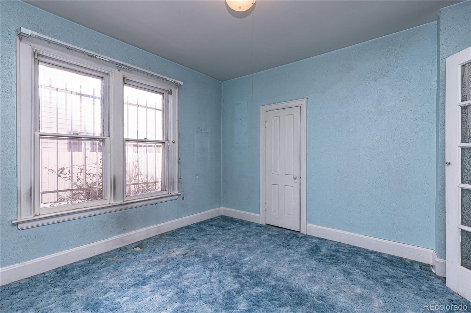 4494 Meade Street Denver, CO 80211 - Photo 8 of 24 an empty room with windows