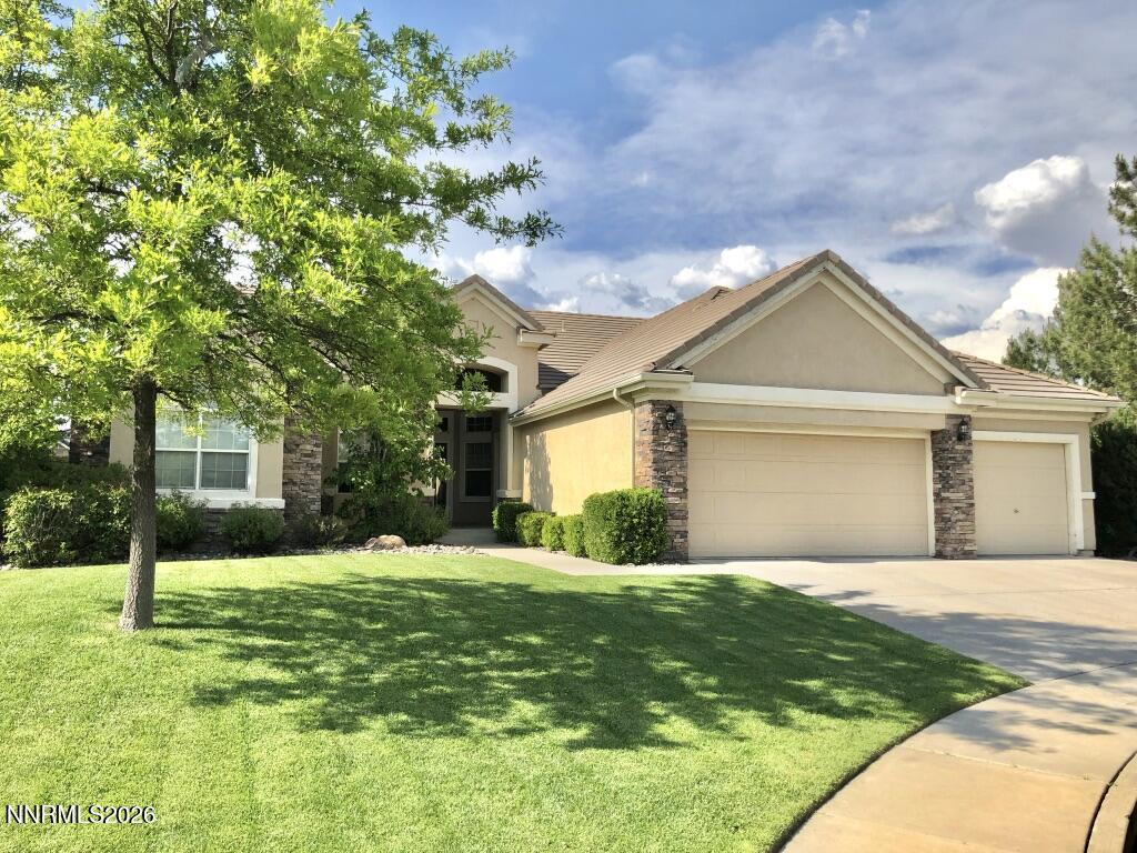 a front view of a house with a yard and garage