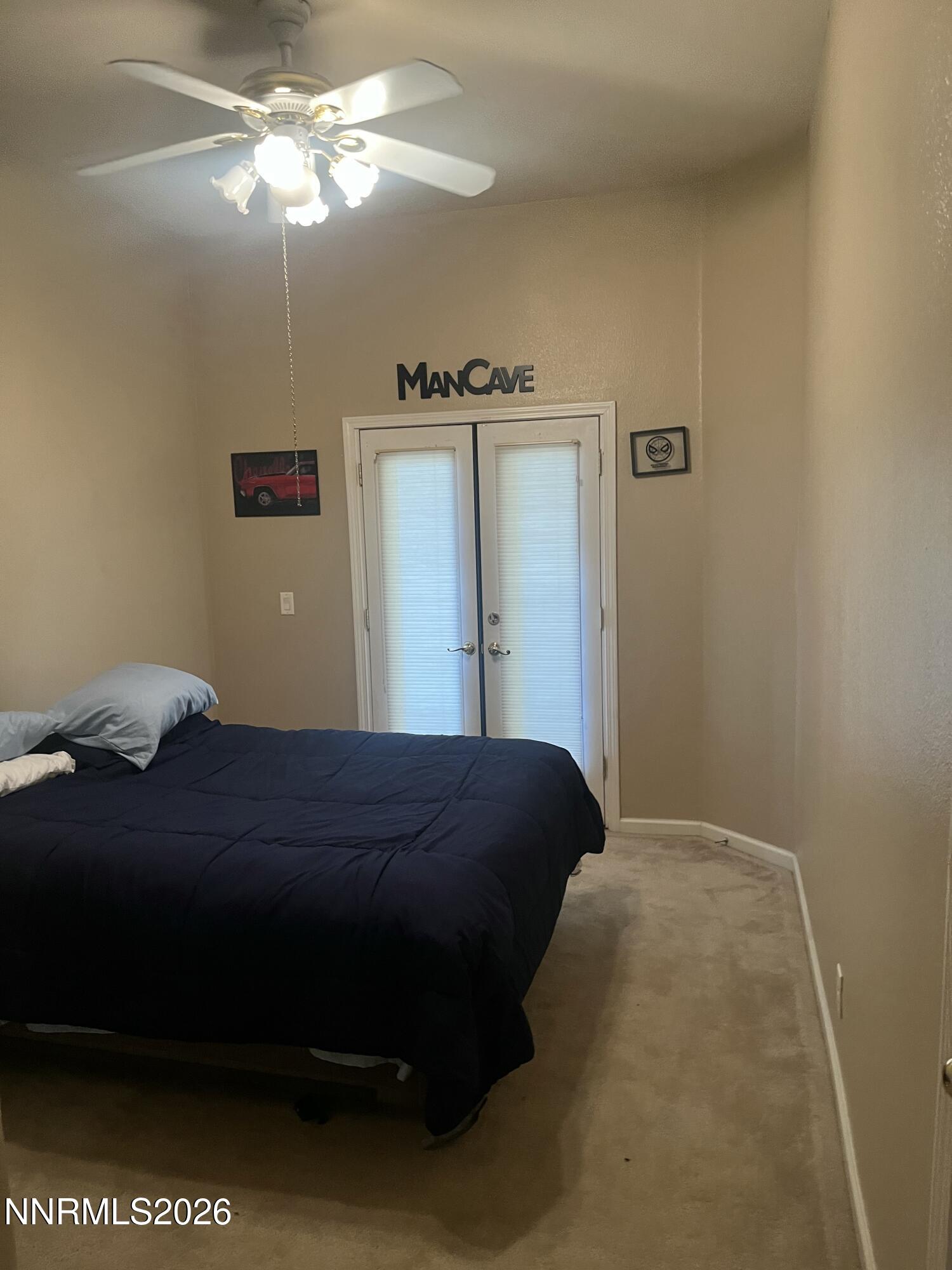 1895 Vintner Court Reno, NV 89519 - Photo 18 of 30 a bedroom with a bed and a chandelier